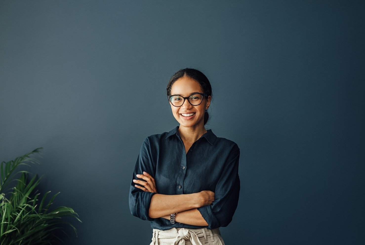 Woman smiling against a blue wall