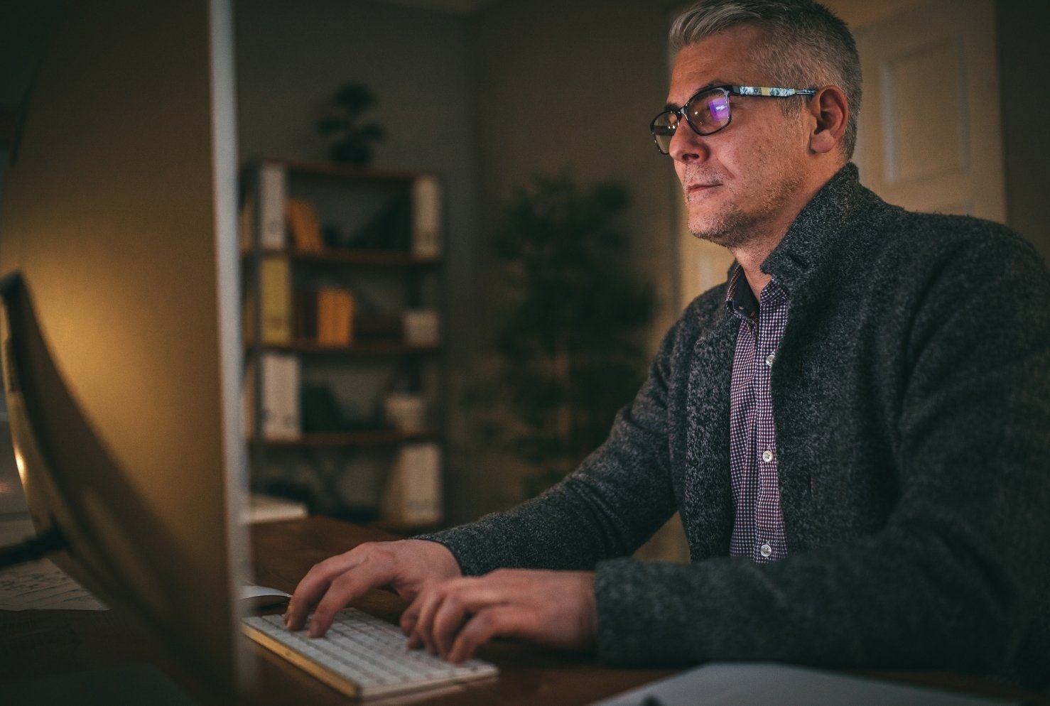 Professional man working at a desk in a modern office.